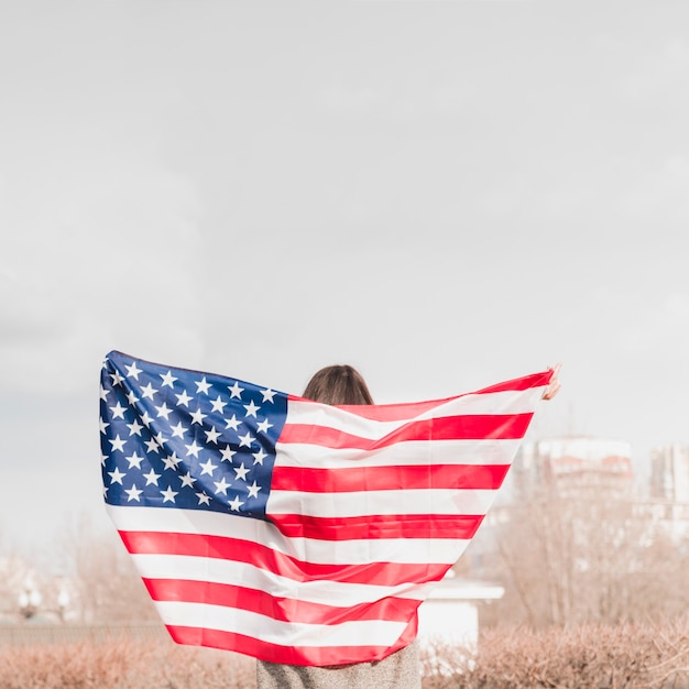 Free photo woman walking with american flag