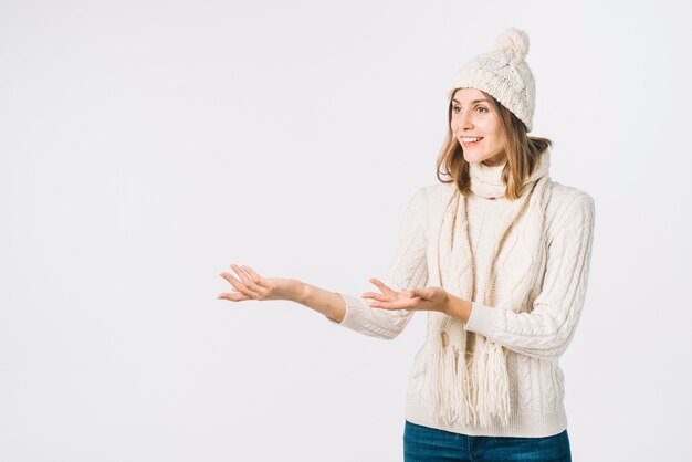 Woman in warm clothes gesturing and looking away