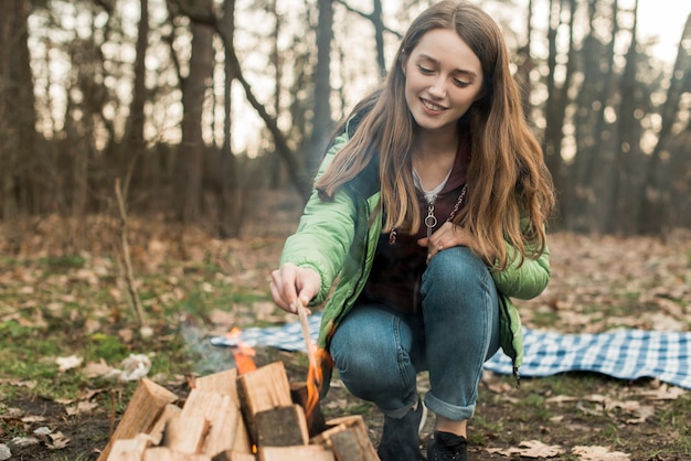 Free photo woman warming at bonfire