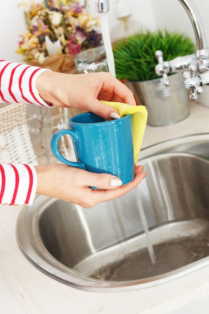 Woman washes tea cup