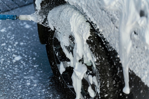 Woman washing her car outdoors