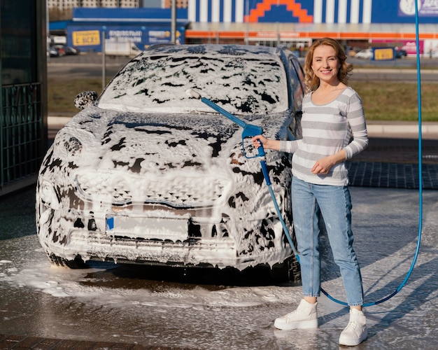 Woman washing her car outdoors