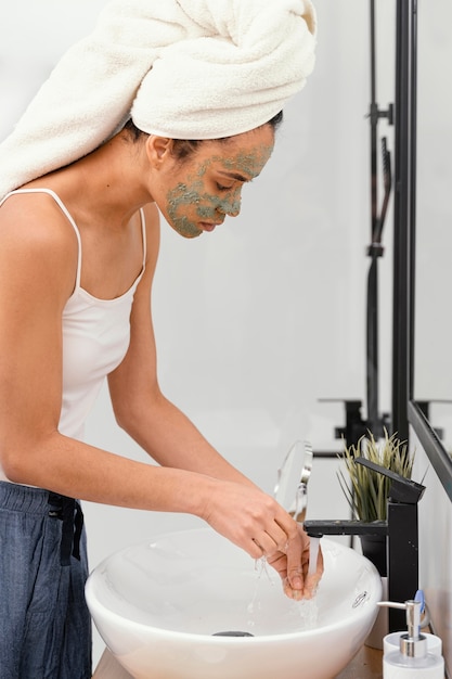 Woman washing off natural ingredients from her hands