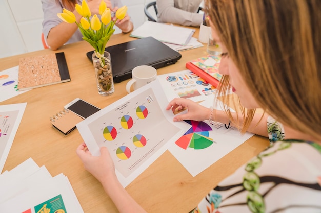 Woman watching diagrams on paper