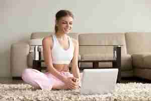 Free photo woman watching fitness video tutorial online