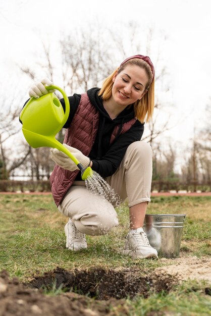 Woman watering a plant she planted