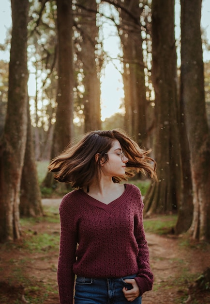 Free Photo woman waving her hair in the forest