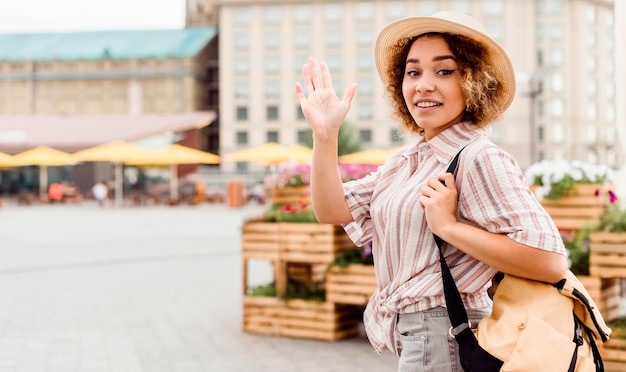 Woman waving with copy space