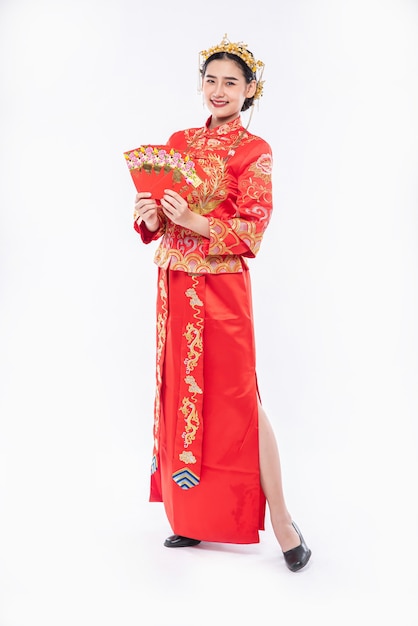 Free Photo woman wear cheongsam suit and black shoe glad getting gift money from boss in chinese new year