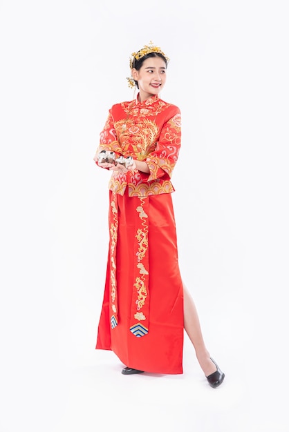 Free Photo woman wear cheongsam suit and black shoe ready to give the gift money to relative