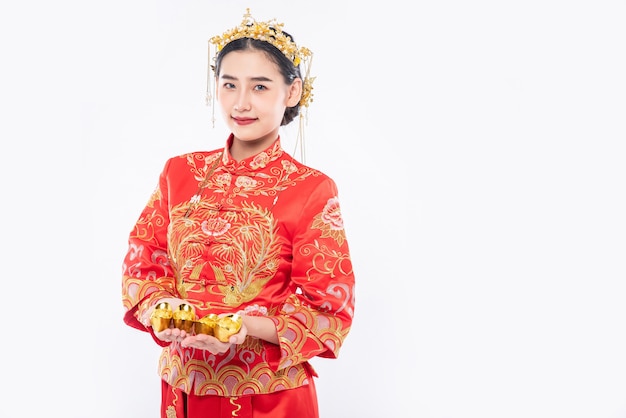 Woman wear Cheongsam suit and crown give gold to her family for lucky in chinese new year