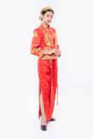 Free photo woman wear cheongsam suit promote to welcome traveller shopping in chinese new year