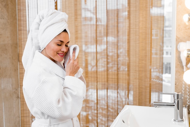 Free photo woman wearing bathrobe in hotel room