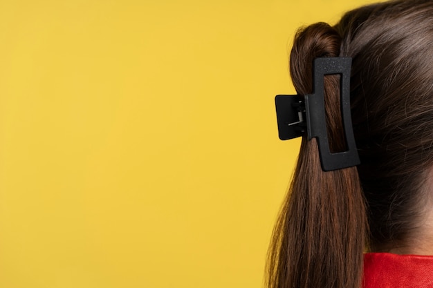 Free photo woman  wearing big hair clip side view