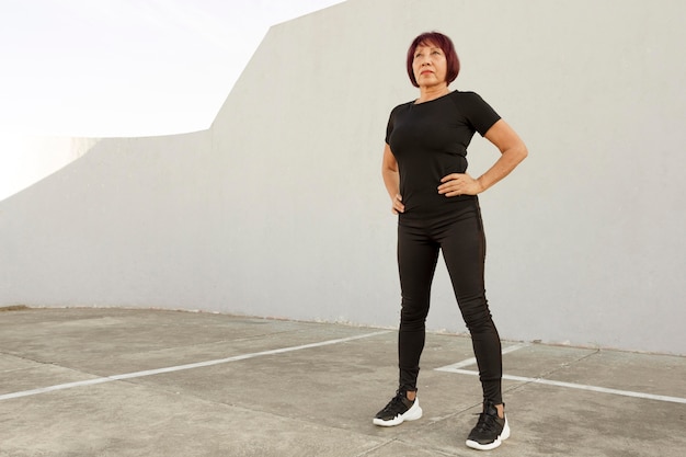 Woman wearing black sport clothes long view