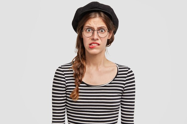 Woman wearing black stylish beret and striped blouse