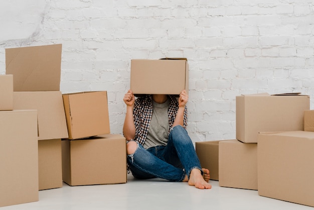 Free photo woman wearing box on head