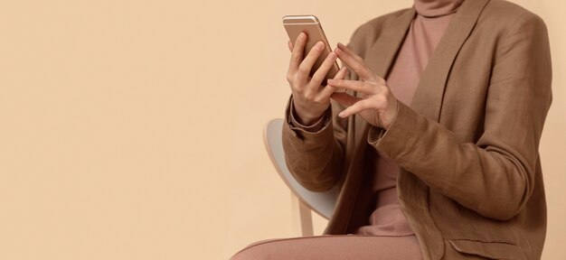 Woman wearing business clothes using mobile phone