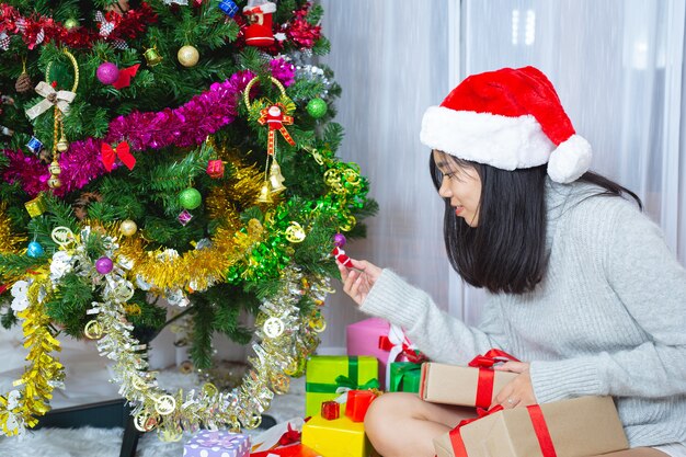 woman wearing christmas hat happy with christmas present