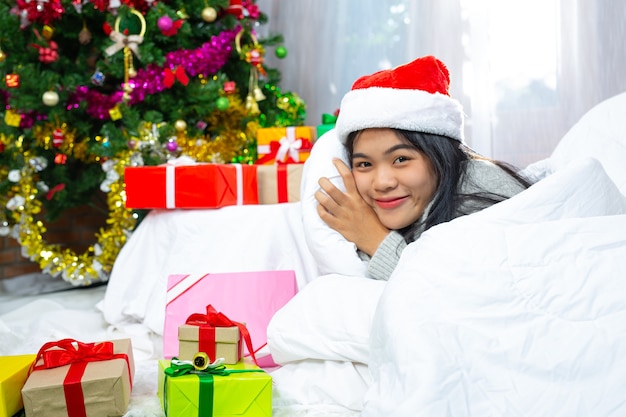 woman wearing christmas hat happy with christmas present