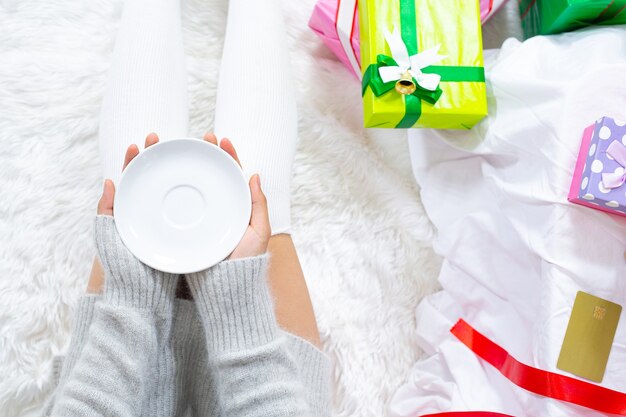 woman wearing christmas hat happy with christmas present