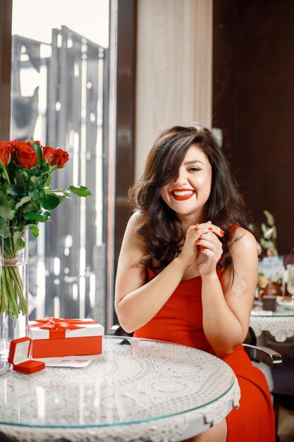 Woman wearing an engagement ring while sitting in restaurant on a date