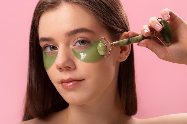 Free photo woman wearing eye patches front view