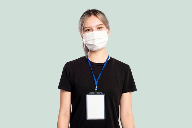 Free photo woman wearing a face mask with a name tag