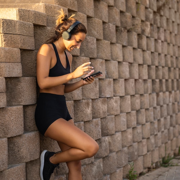 Free photo woman wearing headphones outdoors