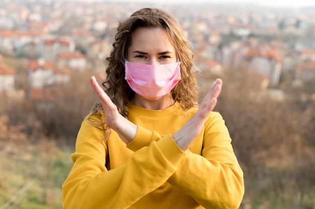 Woman wearing a medical mask outdoors