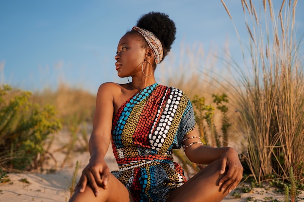 Free photo woman wearing native african clothing in an arid environment