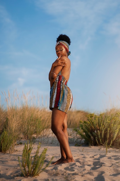 Free photo woman wearing native african clothing in an arid environment