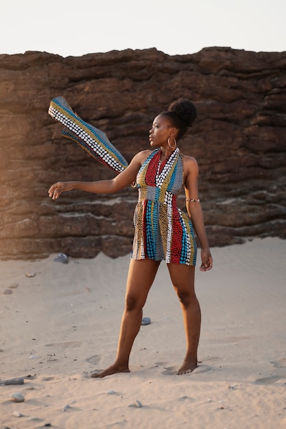 Woman wearing native african clothing at the beach