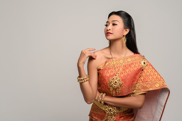 Woman wearing Thai dress that made a hand symbol