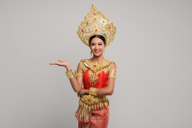 Woman wearing Thai dress that made a hand symbol