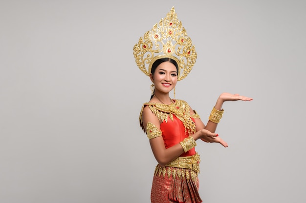 Woman wearing Thai dress that made a hand symbol