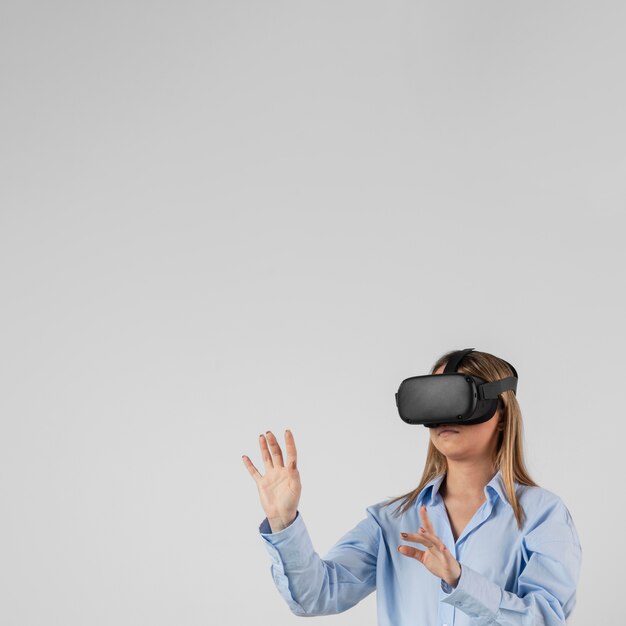 Free Photo woman wearing vr glasses with copy space