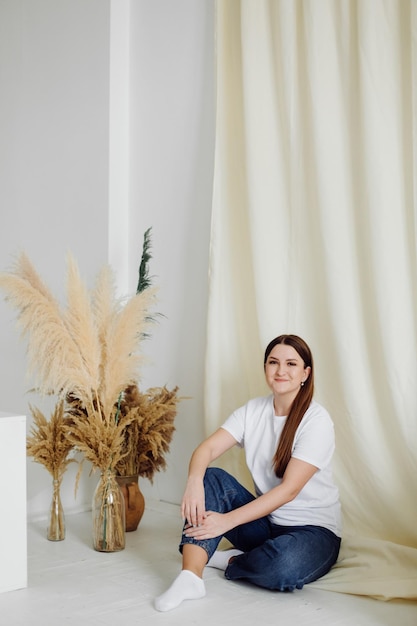 Woman wearing white blank tshirt standing on the background