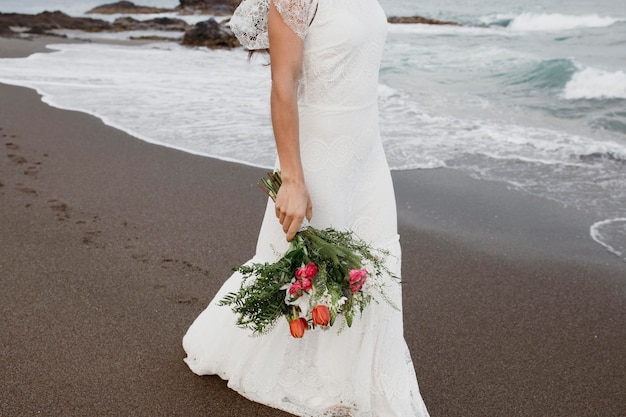 Woman in wedding dress on the beach