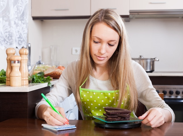 Free photo woman weighing chocolate on scales