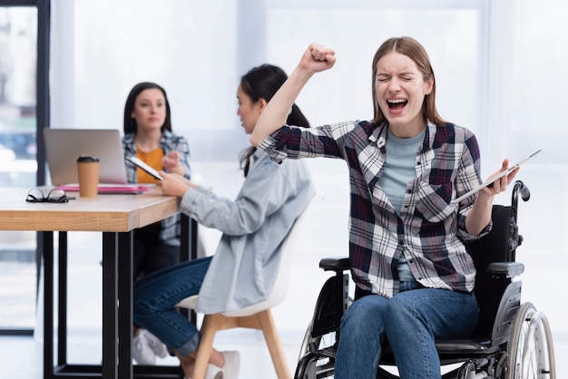 Free Photo woman in wheelchair with tablet