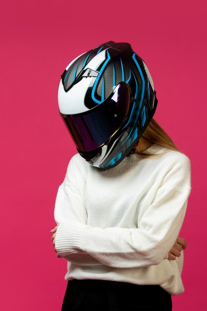 Woman in white pullover with motorcycle helmet