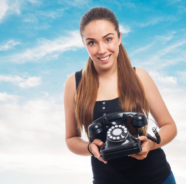 Free photo woman with an antique phone in her hand