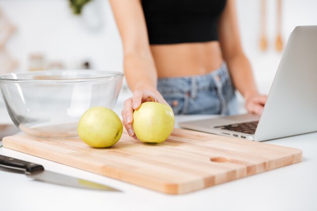 Woman with apple and laptop