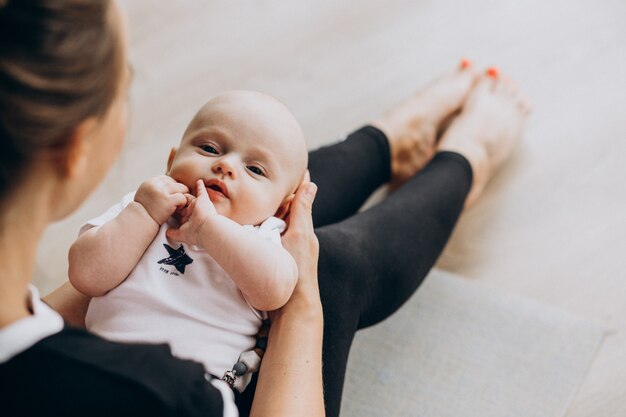 Woman with baby boy practice yoga