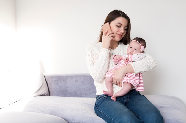 Woman with baby talking on phone