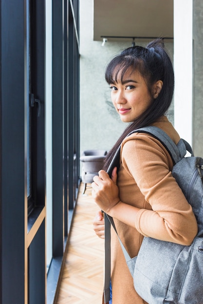 Woman with backpack in beige pullover 