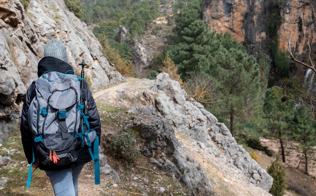 Free photo woman with backpack exploring nature