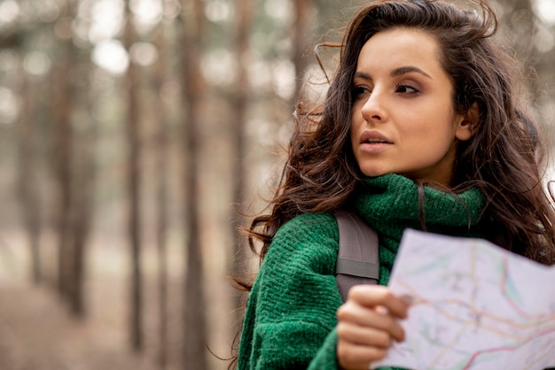 Woman with backpack and map