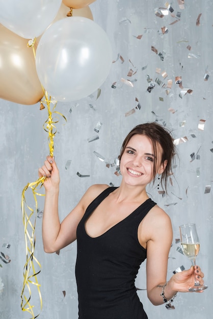 Free Photo woman with balloons and champagne